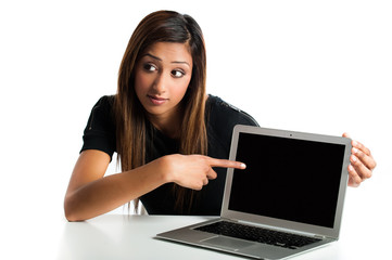 Young Indian woman pointing to laptop.