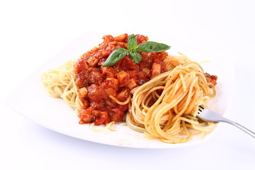 Spaghetti bolognese on a plate being eaten with a fork
