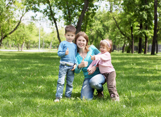 Naklejka na ściany i meble Portrait of mother and children in the park