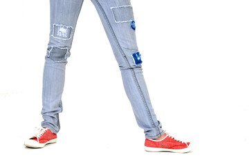 Red sneakers and patched jeans