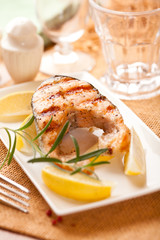 Grilled salmon steak with lemons and rosemary