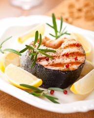 Grilled salmon steak with lemons and rosemary