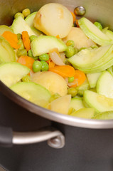 Potatos, carrot, green peas, marrow, onion - are cooking in pan