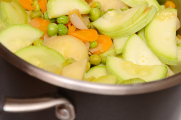 Potatos, carrot, green peas, marrow, onion - are cooking in pan
