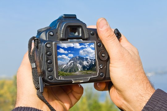 digital photo camera in a people hands