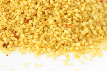 Brown bowl with couscous on white background