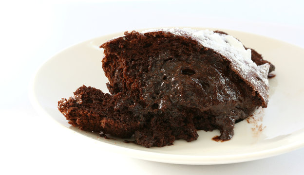 Chocolate souffle light backed cake portion on a plate