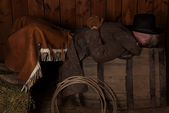 cowboy laying on barrel
