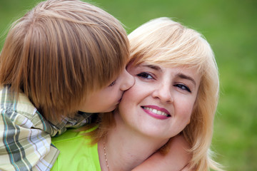 Happy mother with the son in park