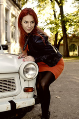 redheaded girl near the old car