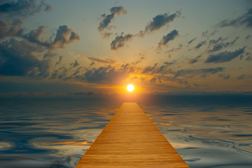 Obraz na płótnie Canvas wooden track goes into the sunset