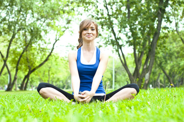 Naklejka na ściany i meble yoga woman on green grass