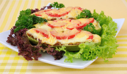 Stuffed zucchini with a mixture of vegetables with tomato