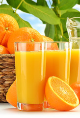 Composition with two glasses of orange juice and fruits