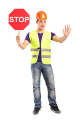Construction worker holding a traffic sign stop