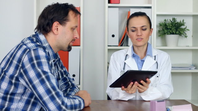 Female doctor with tablet computer and patient
