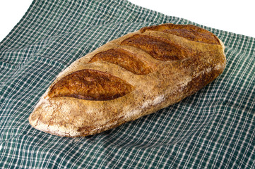 Fresh baked peasant batard on green cloth