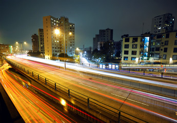 Fototapeta na wymiar light trails on modern city at night