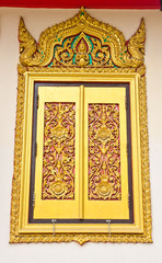 Ancient Golden carving wooden door of Thai temple in Bangkok, Th