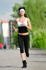 Woman running in green park