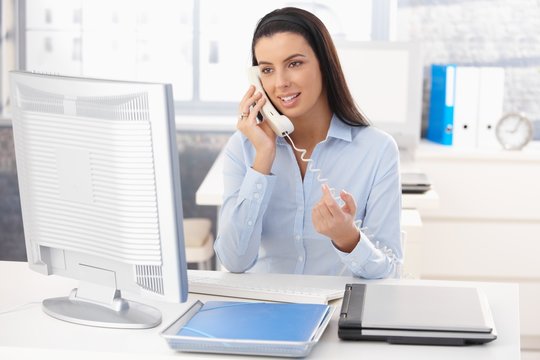 Woman at work on landline call