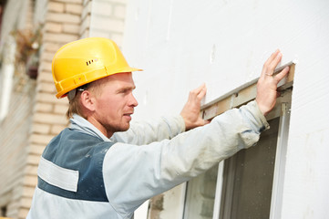 builder facade plasterer worker with level