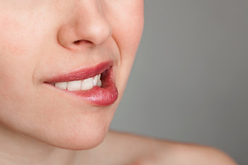 uncertain young woman biting her lips