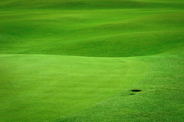 Golf background. Detail of golf field with a ball hole