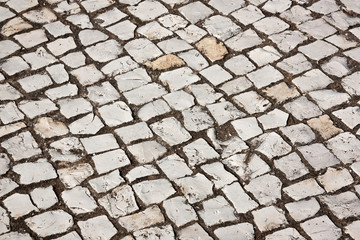 Portuguese cobblestone sidewalk made of cubic stones