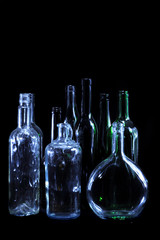 empty bottles in the night on the black background