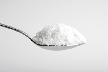 salt in the spoon on white