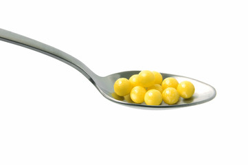 Pill in a spoon on a white background