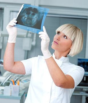 woman dentist with x-ray image