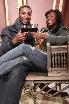 Young couple enjoys red wine at the bamboo foyer
