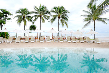 swimming pool by sea at resort hotel luxurious