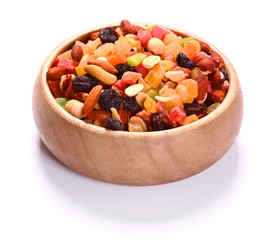 Dried fruits and nuts in plate over white