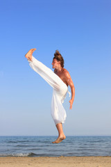 Fototapeta na wymiar Capoeira dancer on the beach