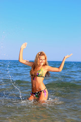 Sexy bikini model having fun in the ocean