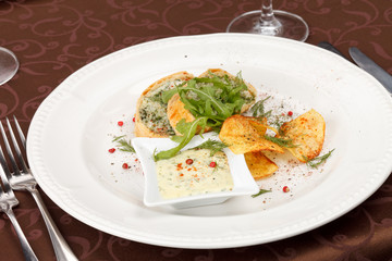 fish pie with sauce and potato chips