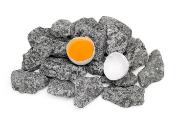 Broken egg on stones