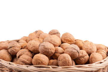 Walnuts in wooden basket on the white background