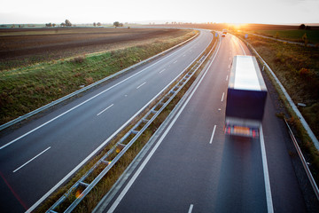 Fototapeta na wymiar highway traffic - motion blurred truck on a highway