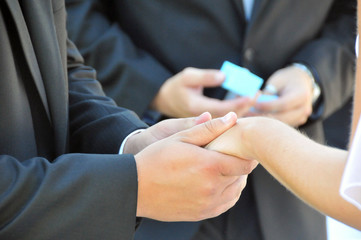 Bride and groom close-up holding hands