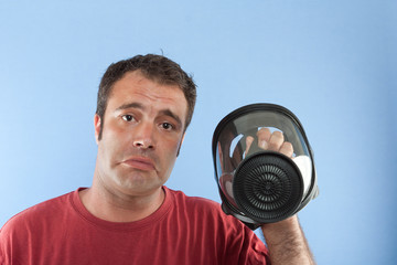 man holding a gas mask