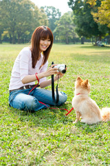 attractive asian woman with dog in the park