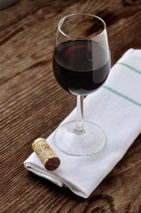 Glass of fine Italian red wine on a table in oak
