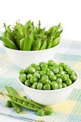 Pods green sweet organic peas in two bowl