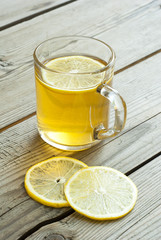 cup of tea and lemon on wooden table