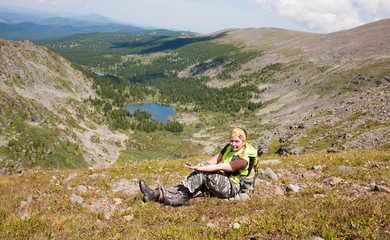 Fototapeta premium tourist in mountains with a compass in a hand