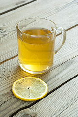 cup of tea and lemon on wooden table